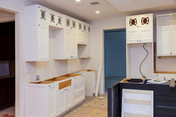 Adding beautiful new furniture to drawers of kitchen cabinet in new house