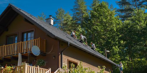 Men worker installing solar photovoltaic panels on a roof, alternative energy, saving resources and sustainable lifestyle concept.